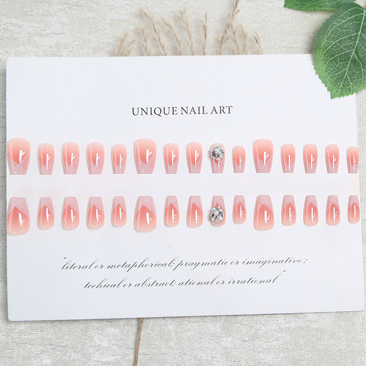 Artificial nail set with filigree tip designs and glamorous rhinestone accents Kalsten