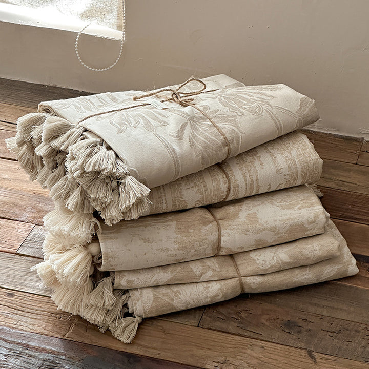 Woven blanket made of cotton blend with decorative tassels
