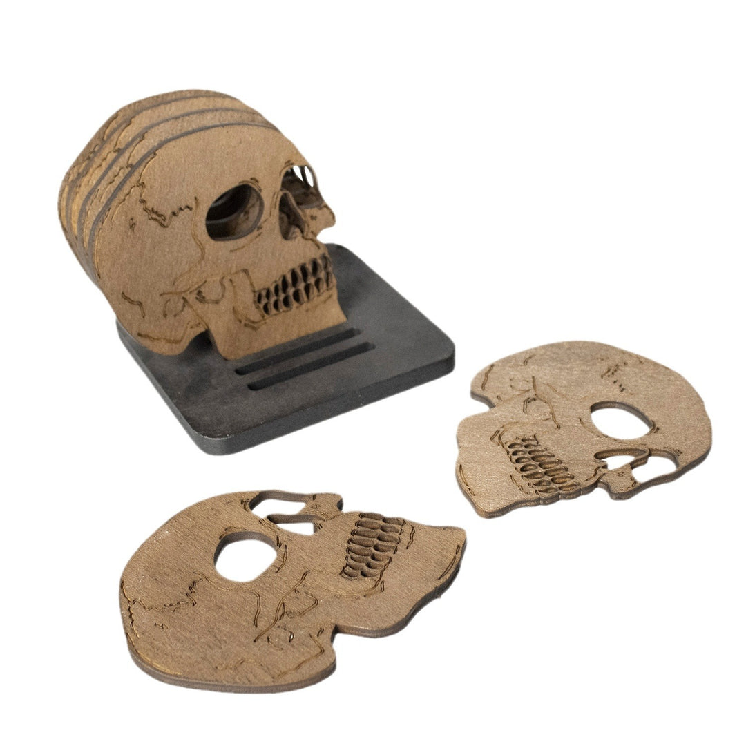 Set of laser-engraved wooden coasters in skull shape with storage stand