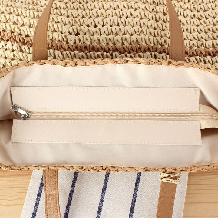 Handbag made of braided natural material with decorative tassel pendant Kalsten