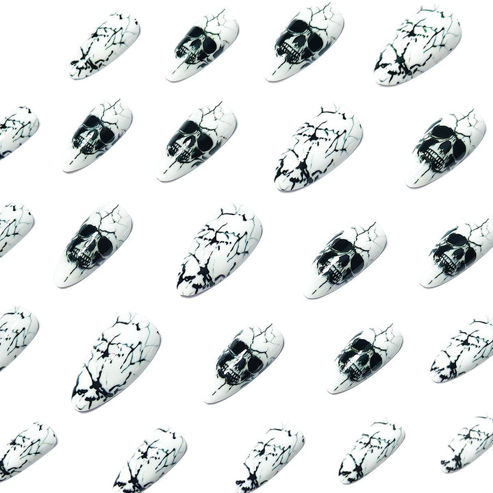 Artificial nails with playful skull design and crackle effects Kalsten