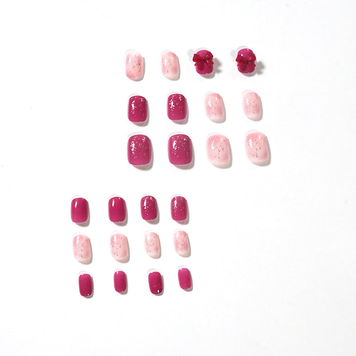 Artificial nail art with glitter embellishments and cute bow motif Kalsten