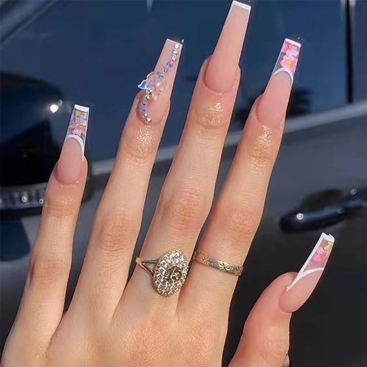 Artificail nail tips in elegant French design with floral accent Kalsten
