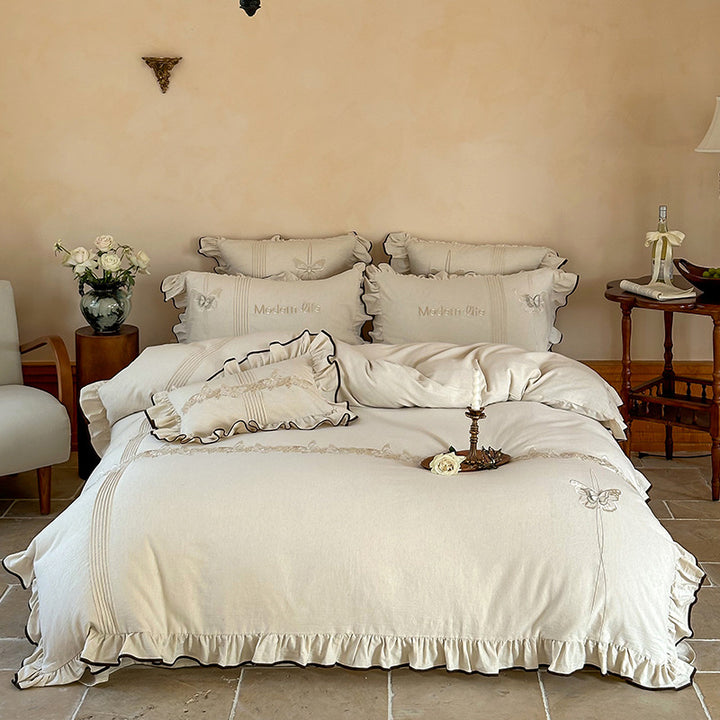 Luxurious bedding set made of cotton satin with embroidered butterfly motif, frill and decorative piping
