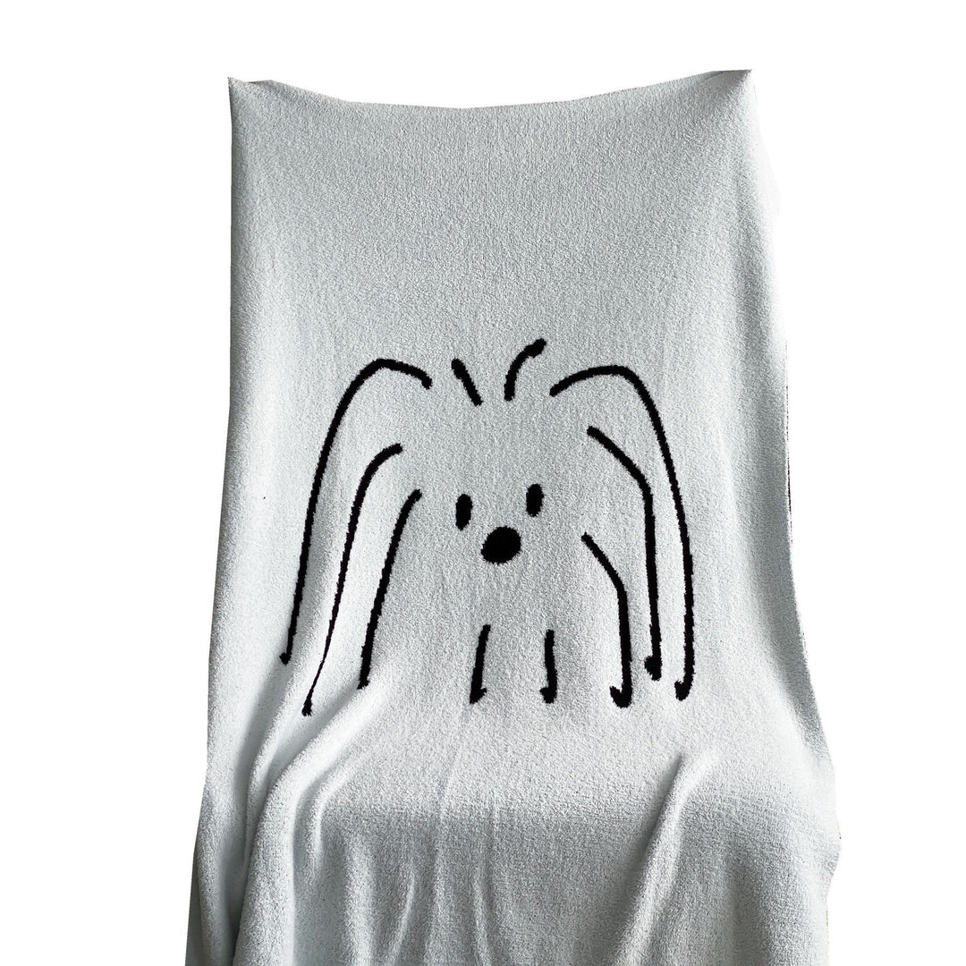 Reversible cuddly blanket made of terry cloth with decorative dog motif