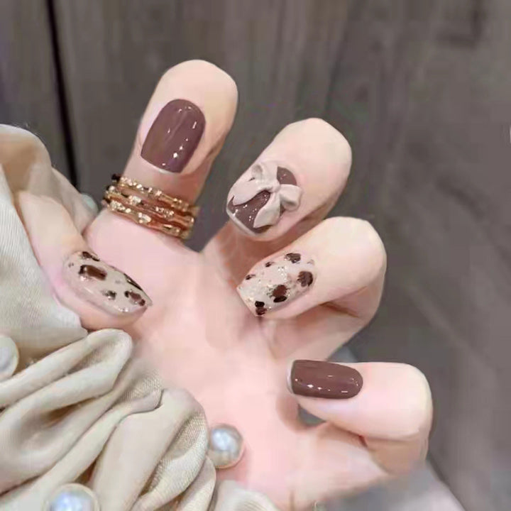 Glamorous artificial nails with heart design and glittering accents Kalsten