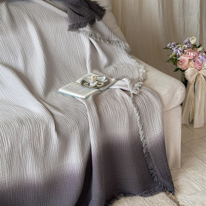 Large waffle blanket with ombre coloring and decorative fringes
