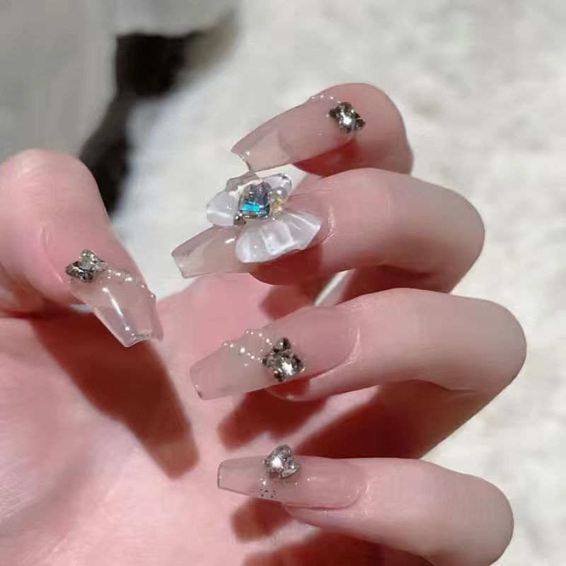 Artistic Nail Art with Glitter and Flower Applications Kalsten
