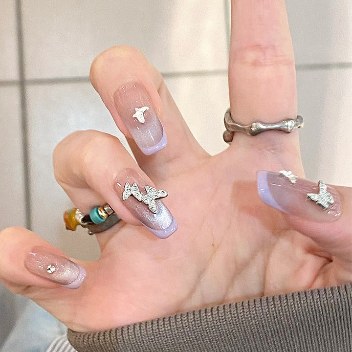 Artificial nail extensions with glitter design and elegant accents Kalsten