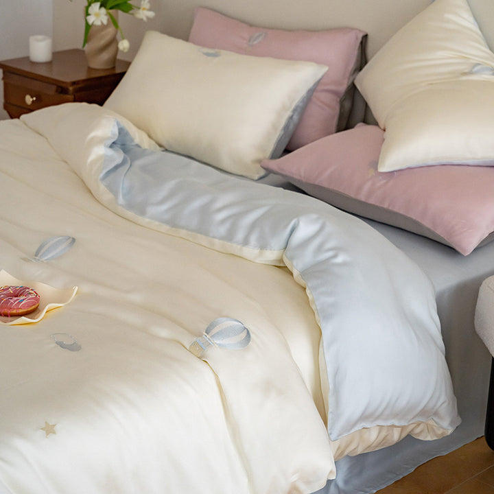 Luxurious satin bedding set with embroidered cherry motifs, reversible function and plush bunny pillow