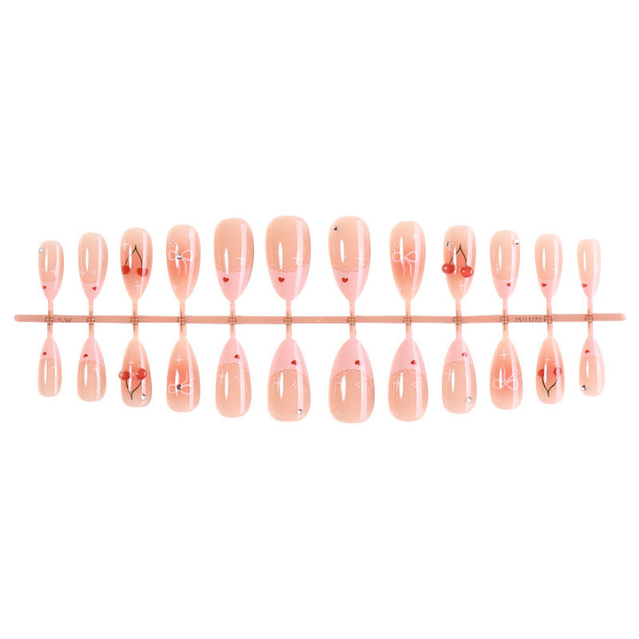 Artifical nails with playful heart and bow designs Kalsten