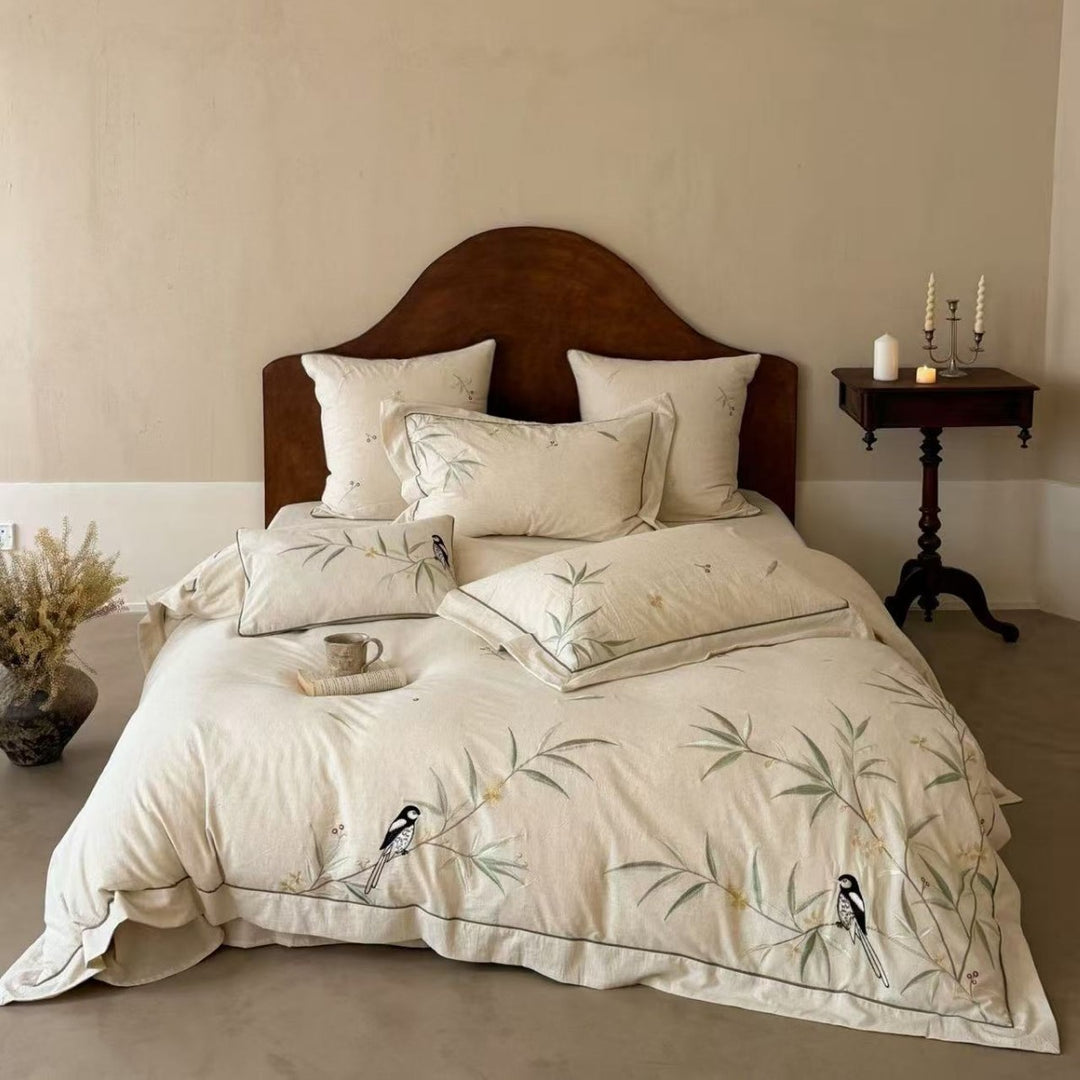 Natural fiber duvet cover set with delicate floral hand embroidery, linen look, and decorative ruffle