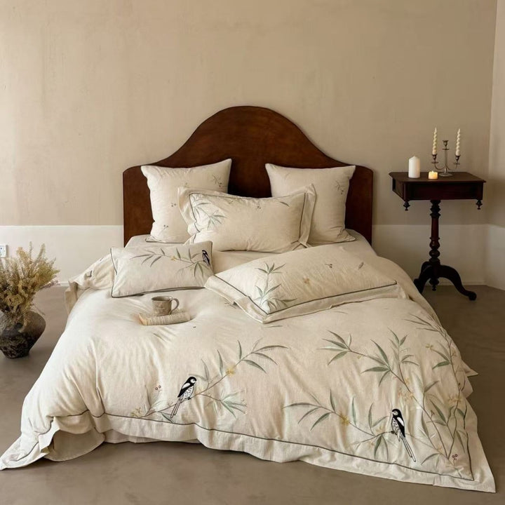 Natural fiber duvet cover set with delicate floral hand embroidery, linen look, and decorative ruffle