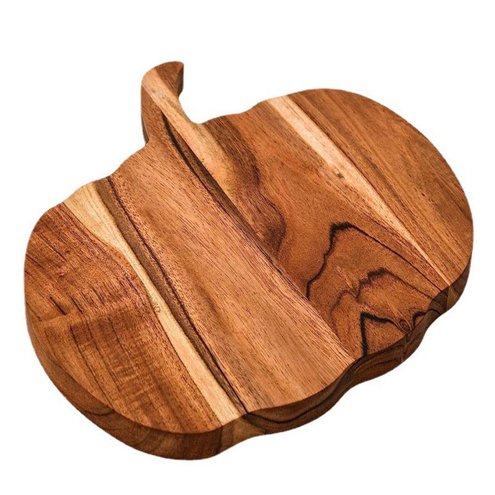 Wood cutting board in pumpkin silhouette made of acacia wood with ergonomic handle