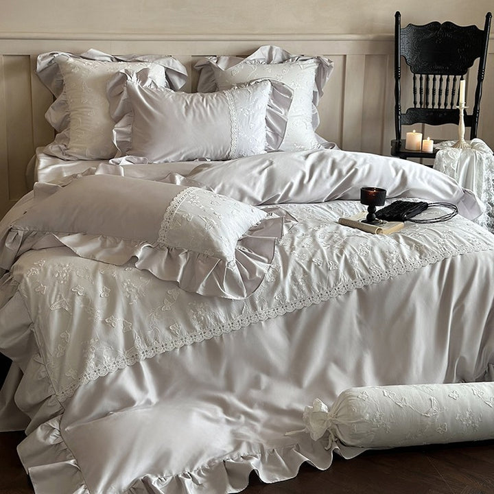 Luxurious satin bedding set with ruffles, lace trim, and fine embroidery