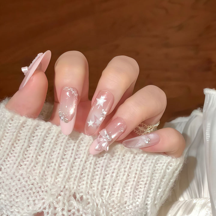 Artificial nail tips with glamorous glitter and bow details Kalsten