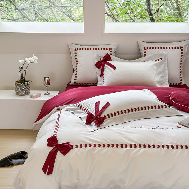 Reversible cotton satin bedding set with decorative bow appliqués