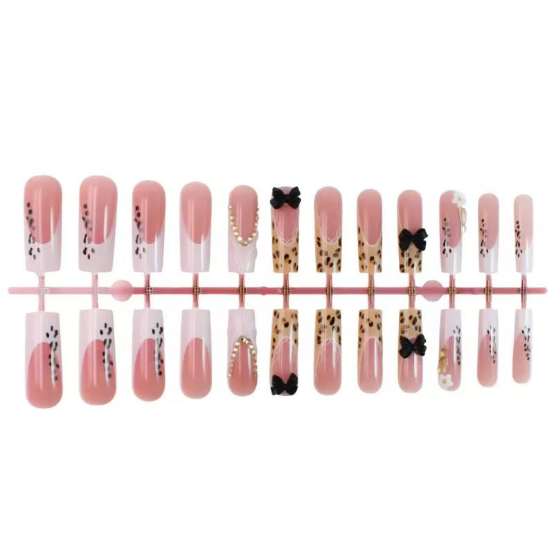 Artistic Press-On Nail Design with Bow and Animal Print Accents Kalsten