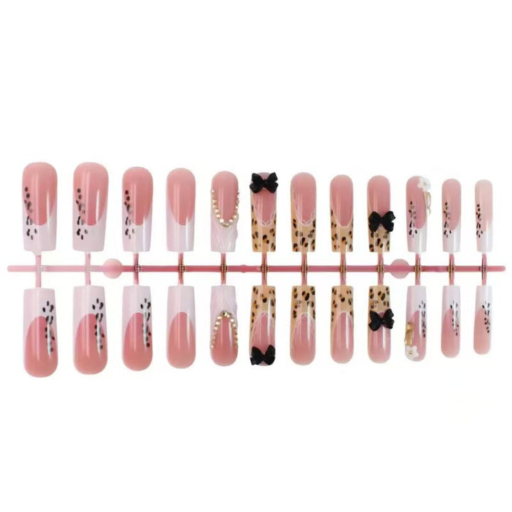 Artistic Press-On Nail Design with Bow and Animal Print Accents Kalsten