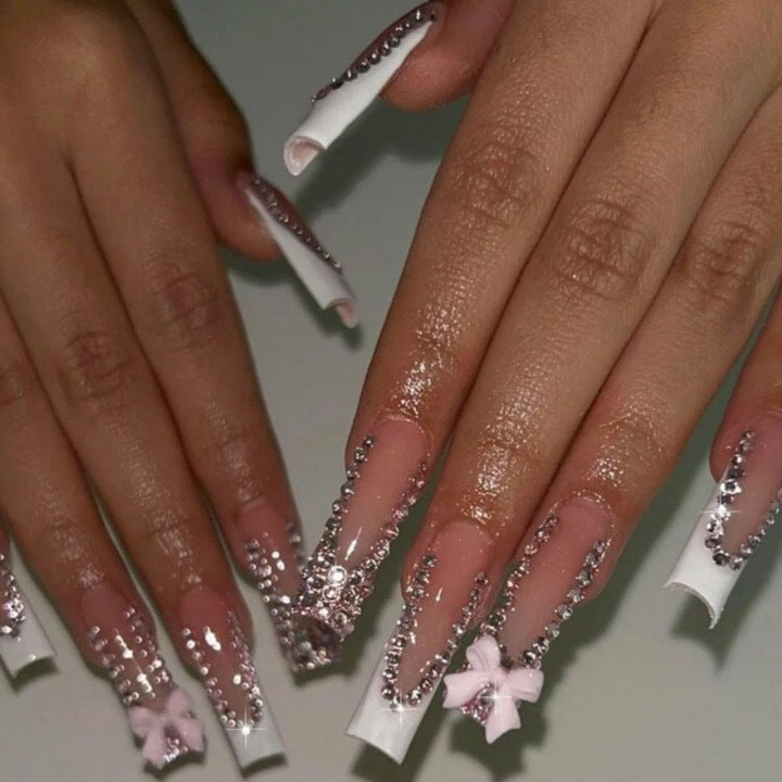 Artificial nails with glamorous rhinestone decorations and floral accents Kalsten