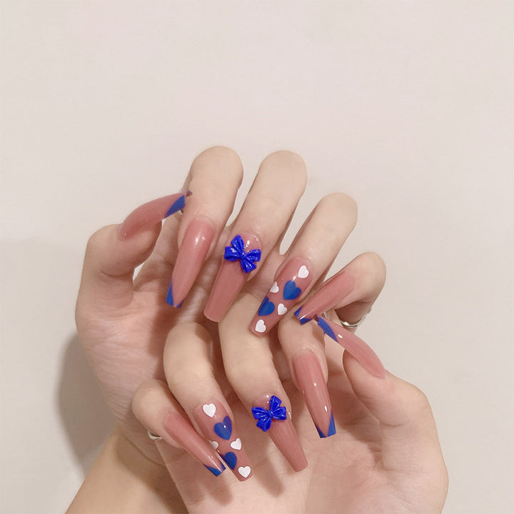 Artful stiletto nails with modern heart and bow motifs Kalsten