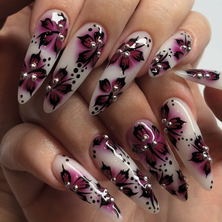 Artful nail art with floral design and rhinestone accents Kalsten