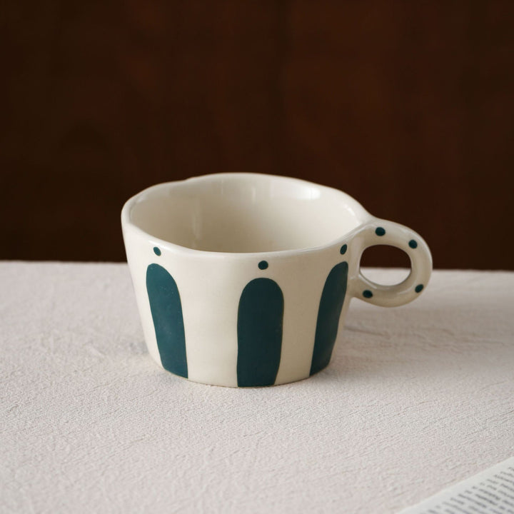 Handmade ceramic mug with ergonomic handle and wavy rim