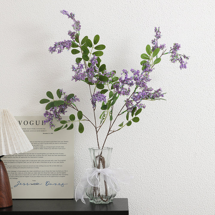Artificial flower branch with vibrant purple flowers