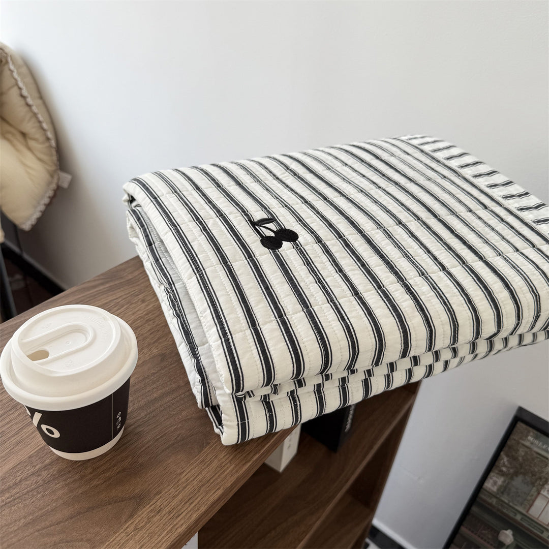 Quilted cotton bedspread with fine striped texture and cherry embroidery