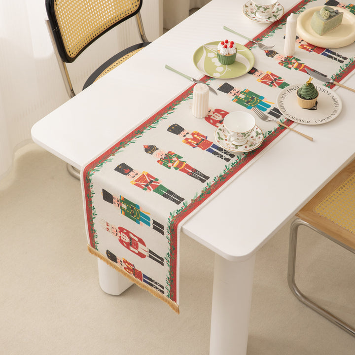 Festive woven table runner with nutcracker motif and golden fringes Kalsten