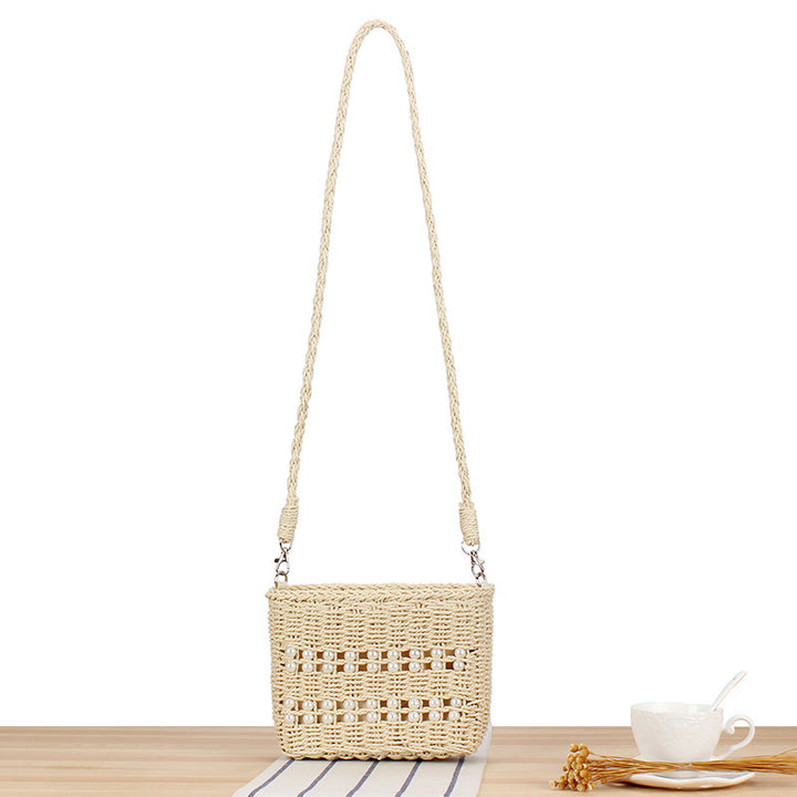 Handbag made of hand-woven natural material with pearl decoration Kalsten