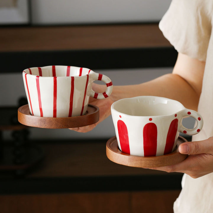 Ceramic espresso cup with round wooden coaster and handcrafted stripe pattern