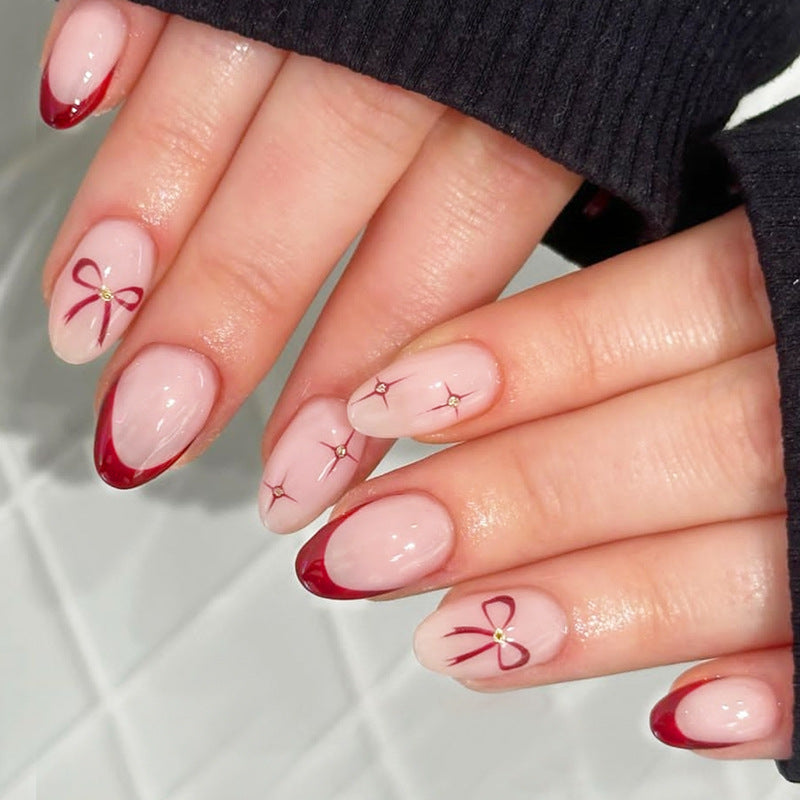 Acrylic nail set with elegant arch design and glitter effects Kalsten