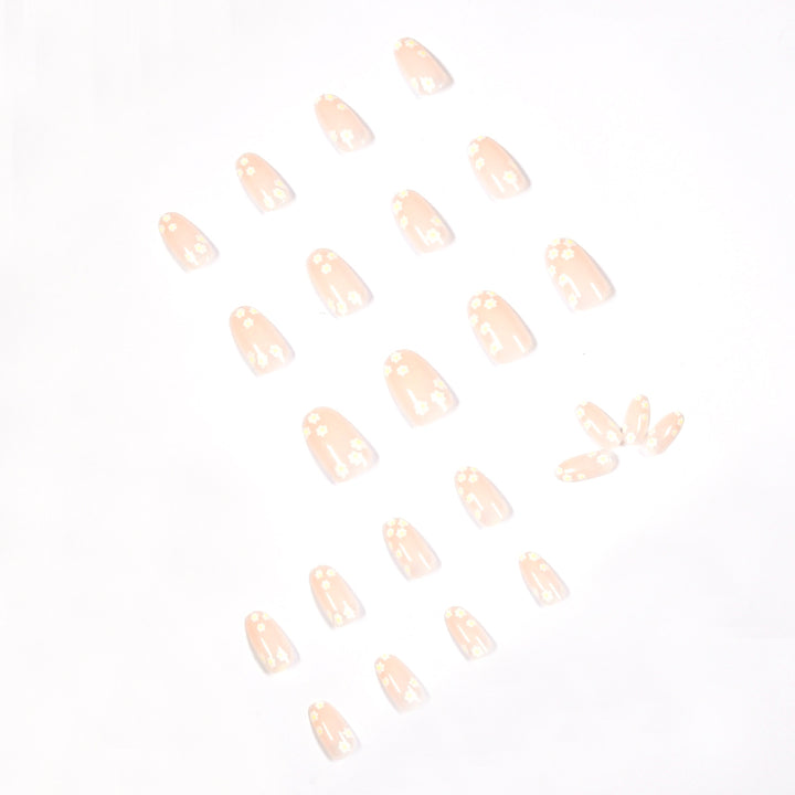 Artificial nail art with floral design and glitter accents Kalsten