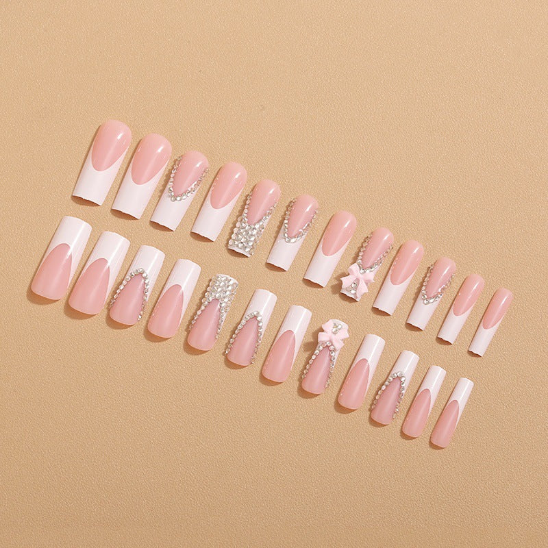 Artificial nails with glamorous rhinestone decorations and floral accents Kalsten