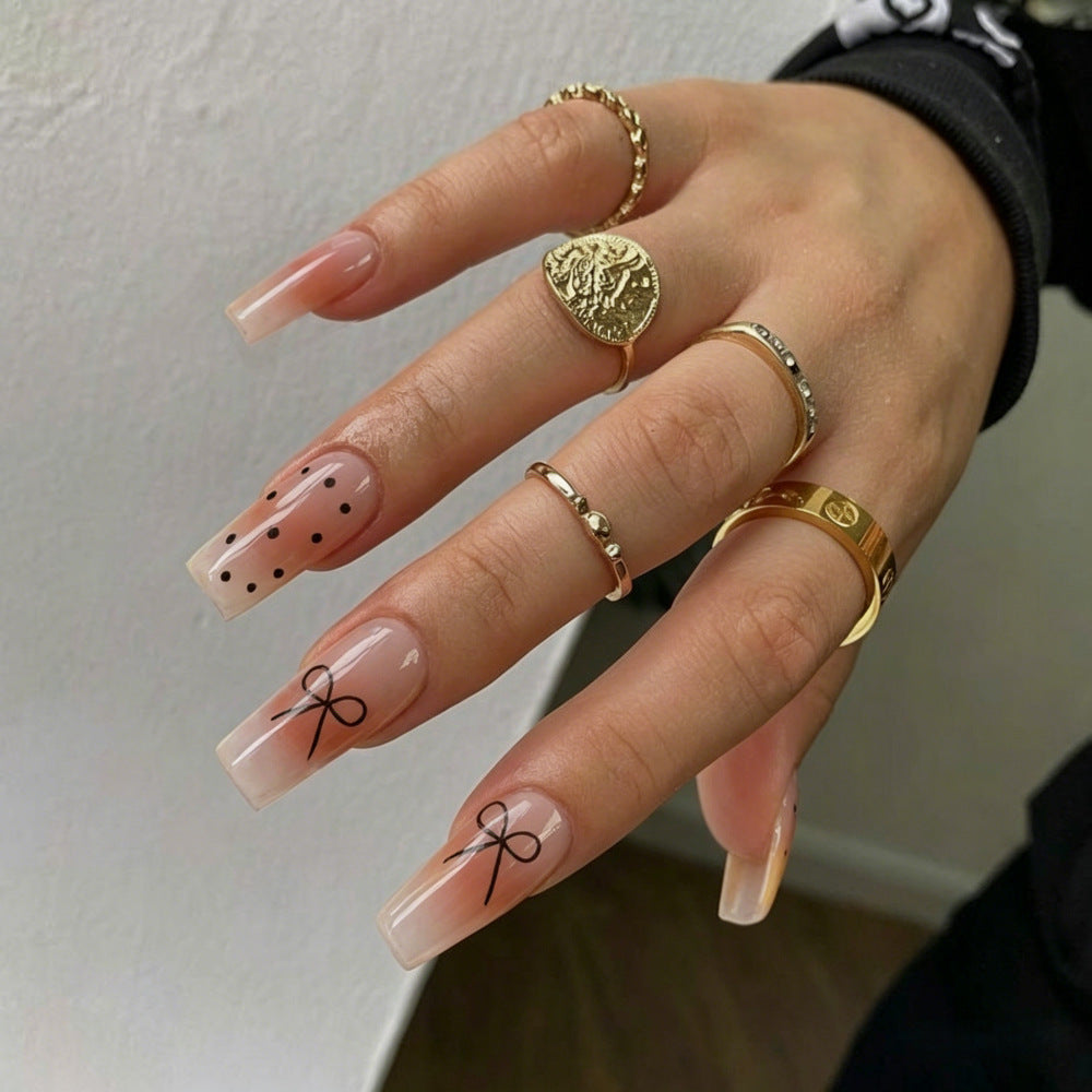 Artificial nails in luxurious French tip design with bow accents Kalsten