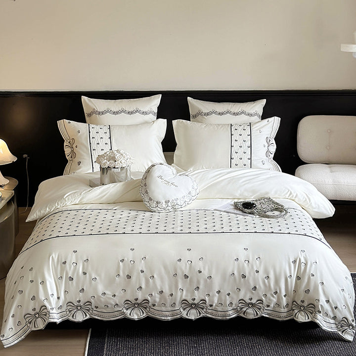 Romantic cotton satin bedding set with embroidered ribbon borders and decorative pillow
