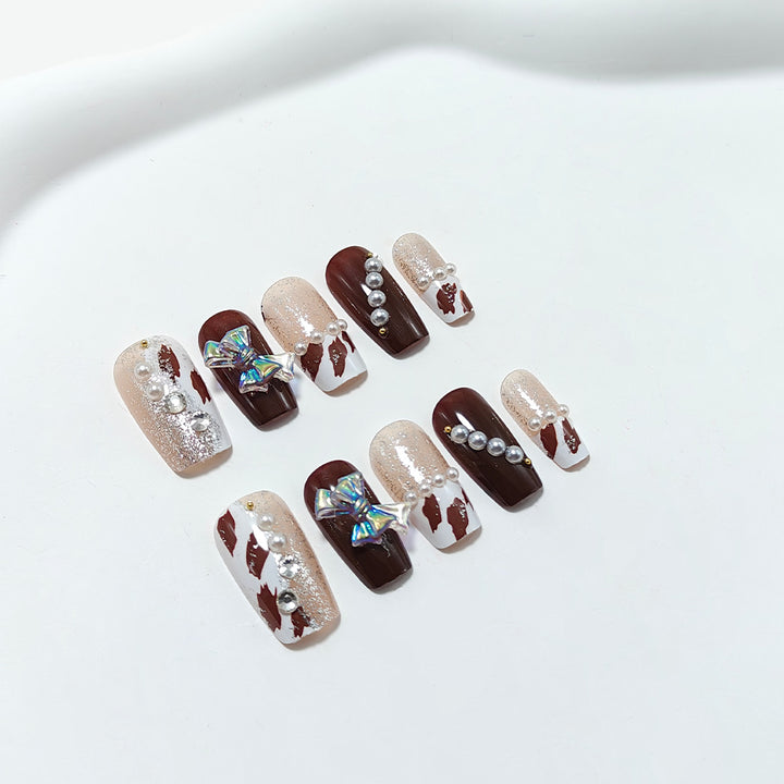 Artificial nails with glamorous rhinestone and bow design Kalsten