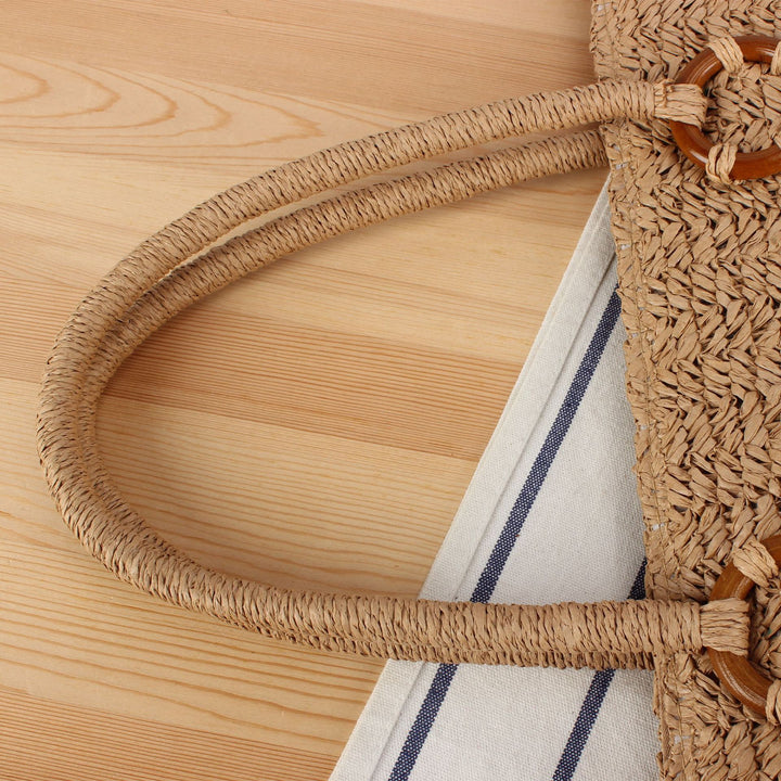 Beach bag made of natural woven material with sturdy carry handles Kalsten