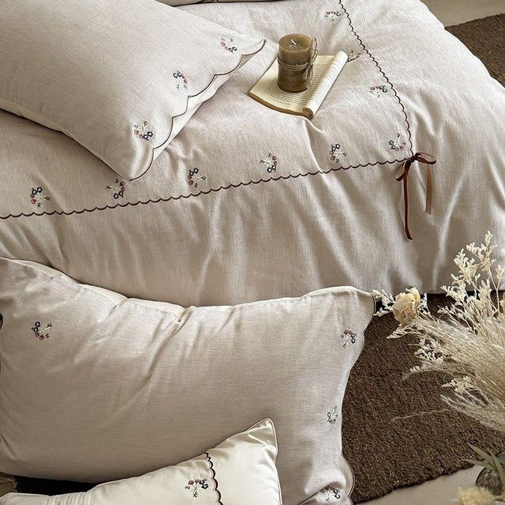 Embroidered bed linen set made of cotton-linen with delicate floral embroidery, wavy edge and ties.