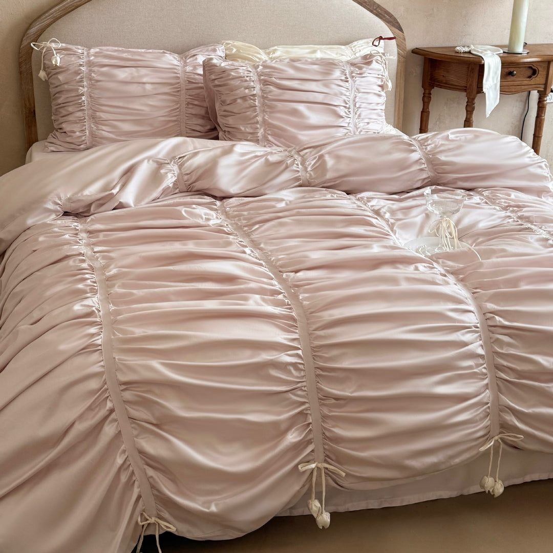 Satin bedding set with gathered drawstring look and tassels