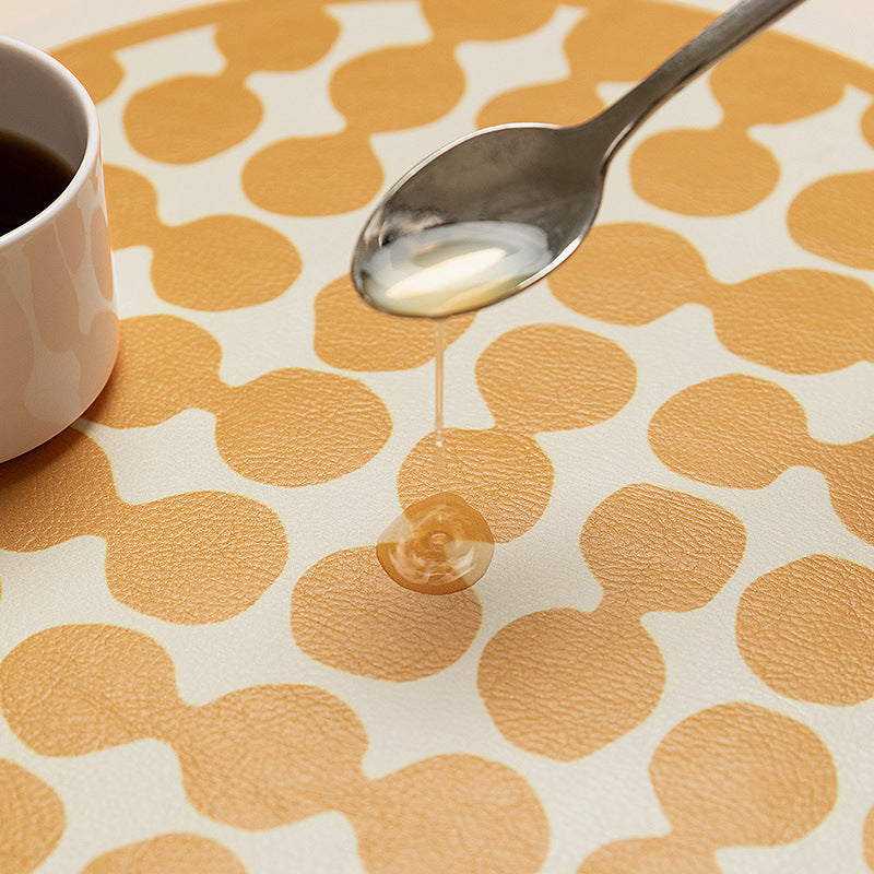 Round wipeable table mat made of PVC with non-slip back and retro geometric pattern
