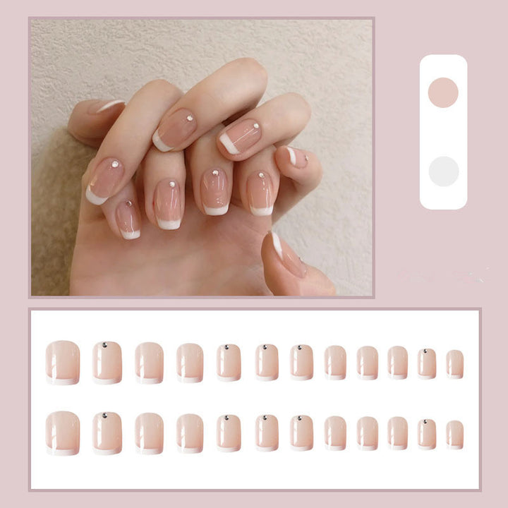 Artificial nails with elegant French tip and rhinestone accents Kalsten