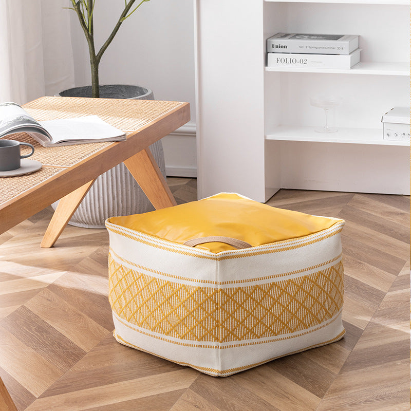 Woven seat pouf with quilted synthetic leather top and carry handle