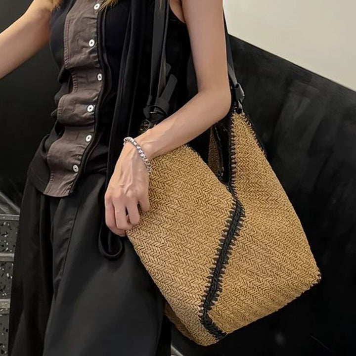 Fashionable beach bag made of woven natural material with leather handles Kalsten