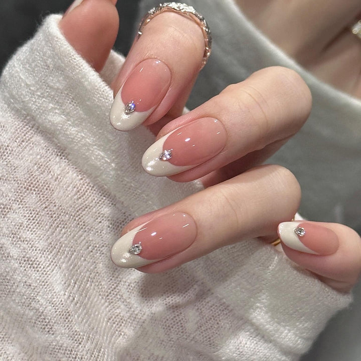 Artificial nails with elegant French style and sparkling accents Kalsten