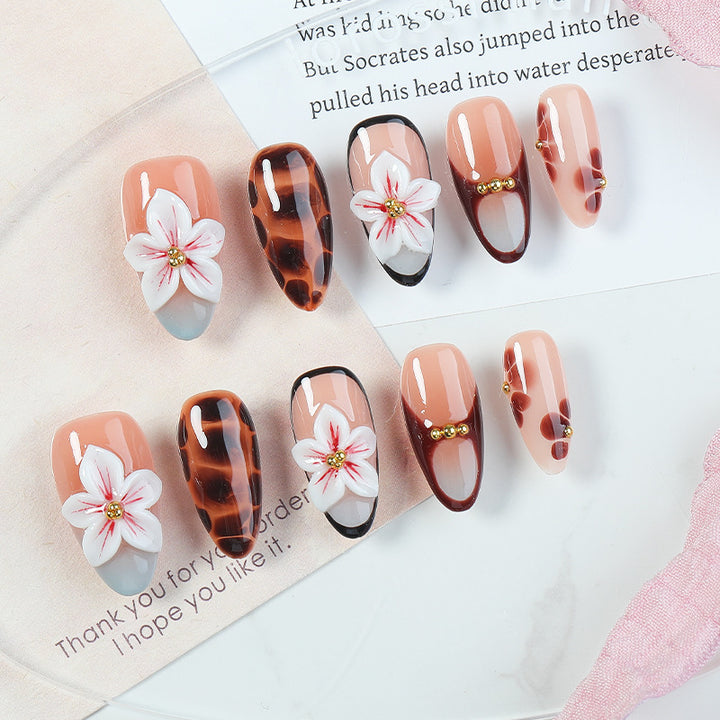 Acrylic nail set with floral accents and elegant embellishments Kalsten