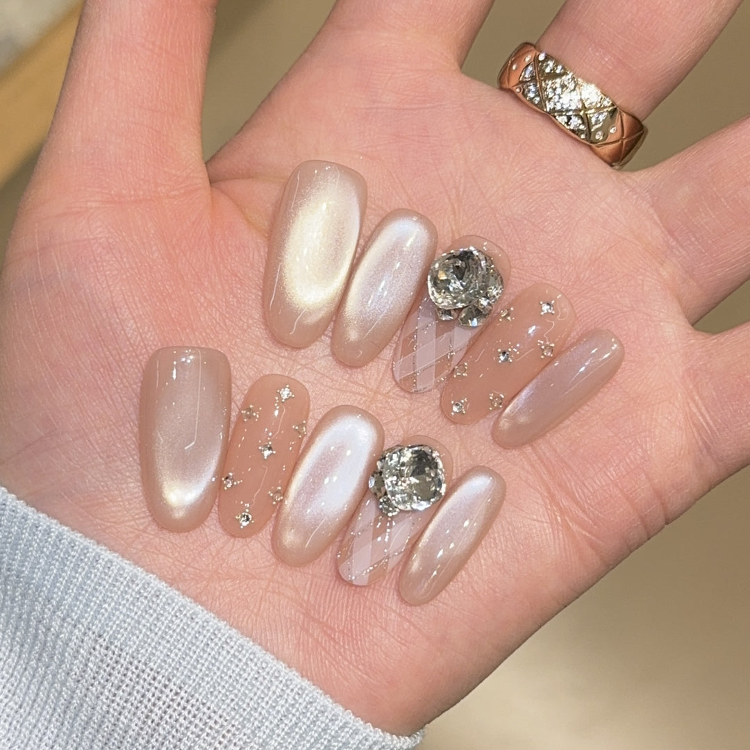 Elegant artificial nails with shimmering effects and rhinestone accents Kalsten