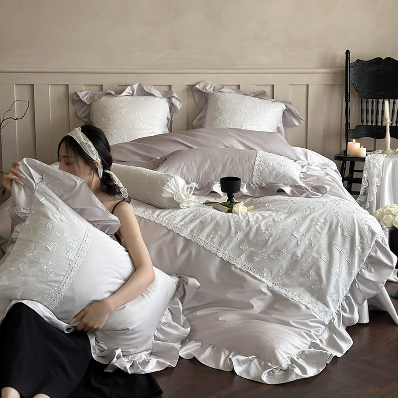 Luxurious satin bedding set with ruffles, lace trim, and fine embroidery