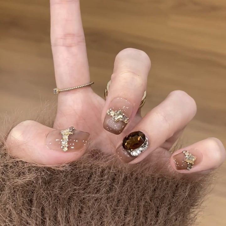 Artificial nail art with glitter and jewelry embellishments Kalsten